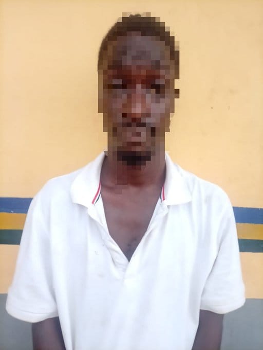 The suspect, Adeshola Muyiwa, in police custody