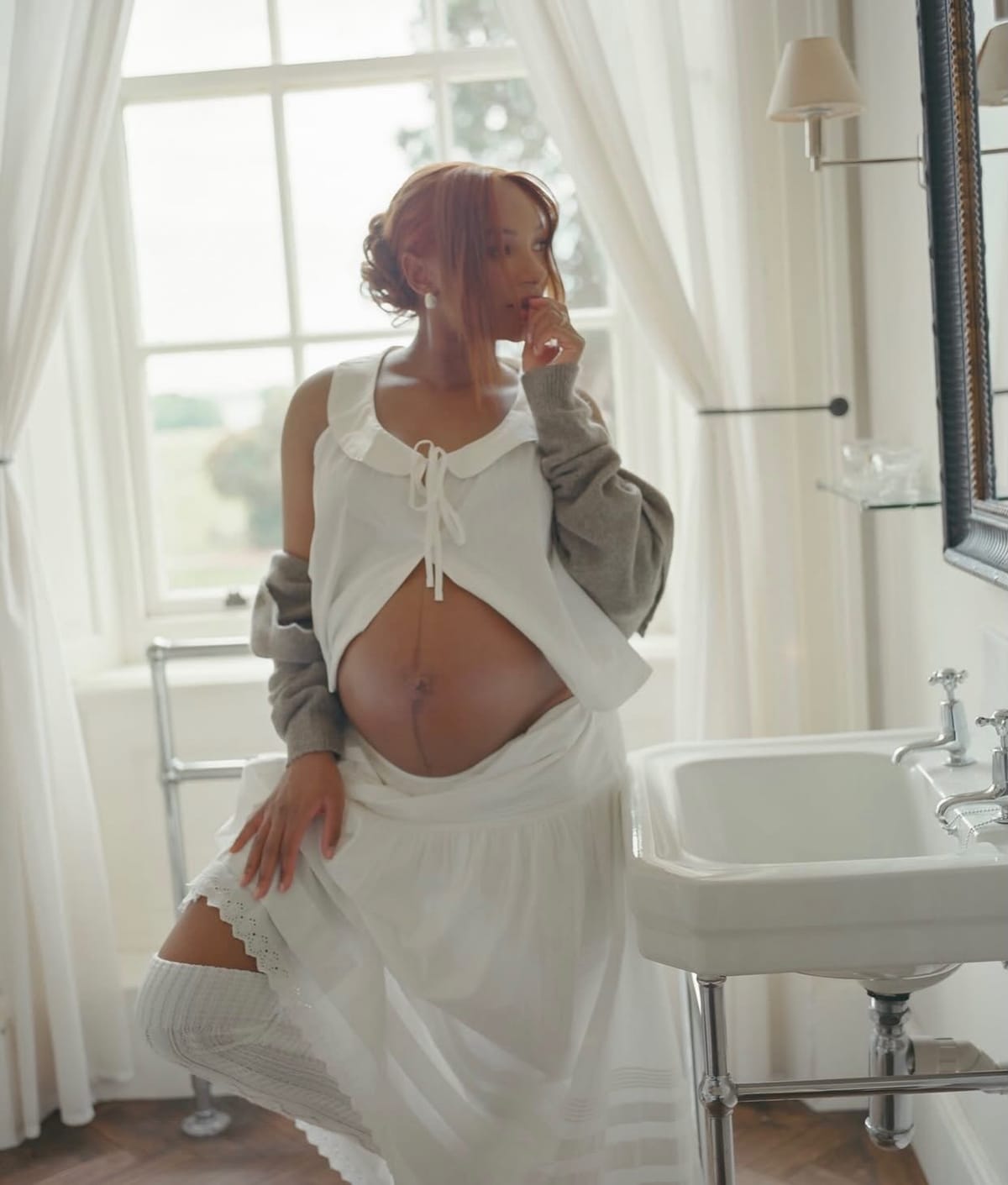 Mr Eazi gently cradling Temi Otedola's baby bump in a shared maternity photo.
