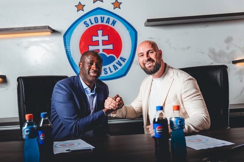 Yaya Toure poses with Slovan Bratislava officials after his appointment as head coach