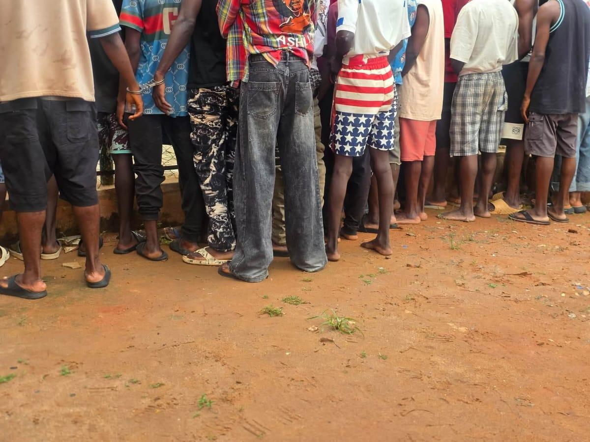 Law enforcement personnel at a site identified as a criminal hideout in Asaba.