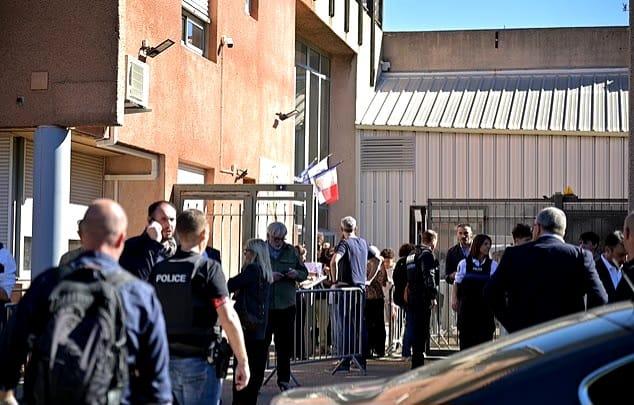 Emergency services or law enforcement personnel at a school, responding to a security incident.