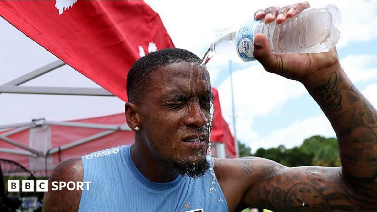 England player Ezri Konsa pouring water on himself to cool down during a training session.