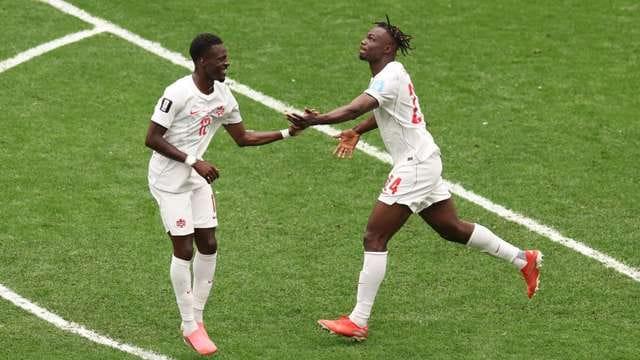A Canadian player challenges a Swiss opponent during their decisive World Cup Group B fixture.