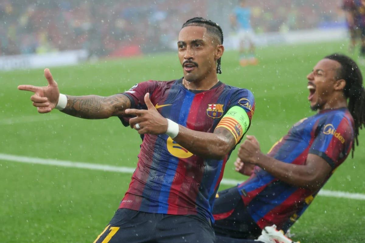Raphinha celebrates a goal for Barcelona during a UEFA Champions League match at Camp Nou.