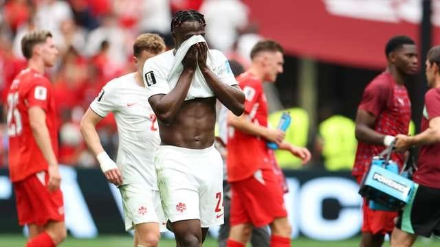Players vying for possession during the Canada vs Switzerland World Cup encounter.