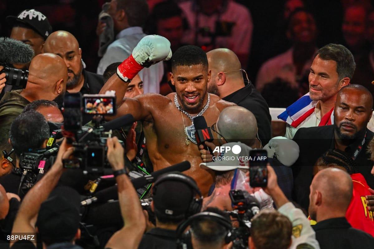 Anthony Joshua raising his arms in triumph after his victory over Jake Paul in a non-title heavyweight match in Miami, Florida.