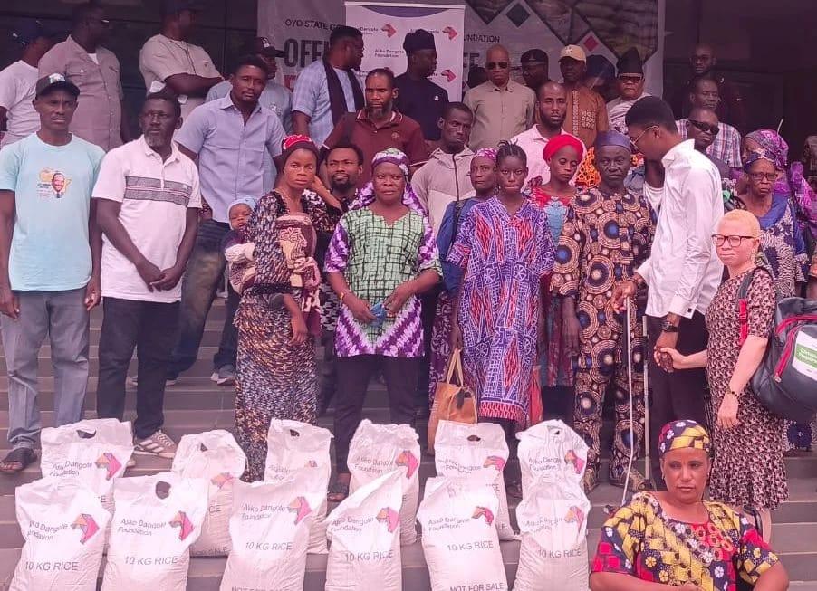 Beneficiaries from various local government areas receiving 10kg bags of rice during the food relief exercise in Oyo State.