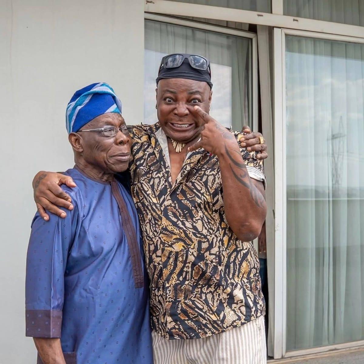 Former President Olusegun Obasanjo and entertainer Charly Boy share a moment.