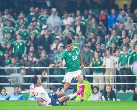 Jarell Quansah slides in on Jesús Gallardo during England’s victory over Mexico at the Azteca Stadium.