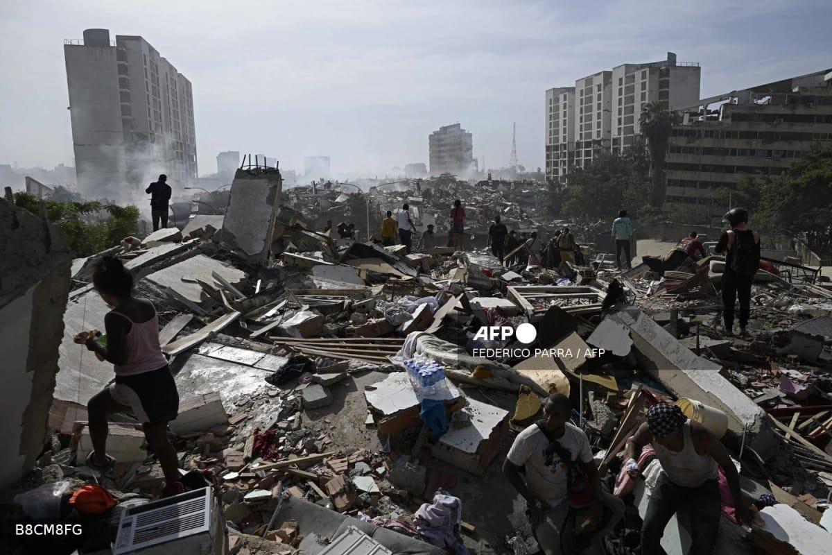 Residents navigate through the extensive debris in Caraballeda, La Guaira state, following the twin earthquakes that struck Venezuela on June 25, 2026.
