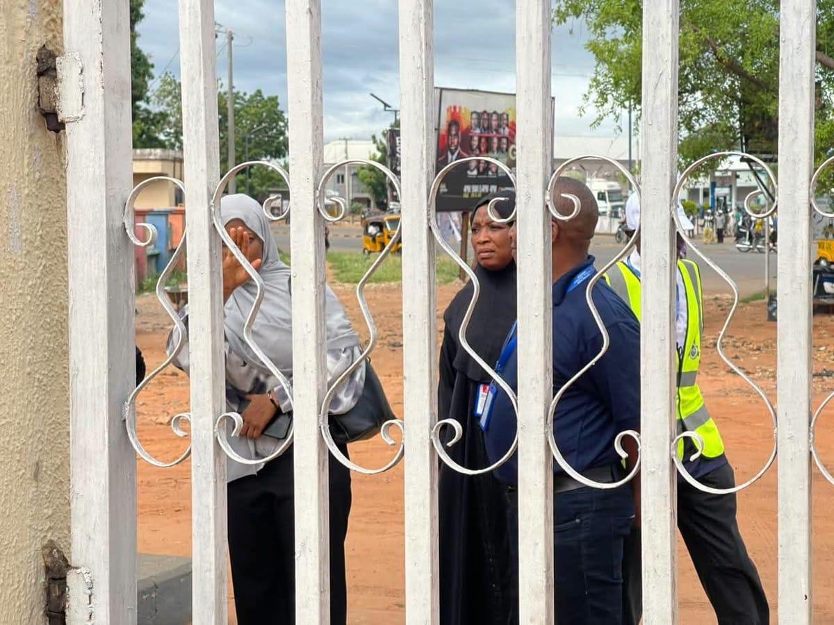 Security personnel by the locked gate of the Nasarawa State Internal Revenue Service office.