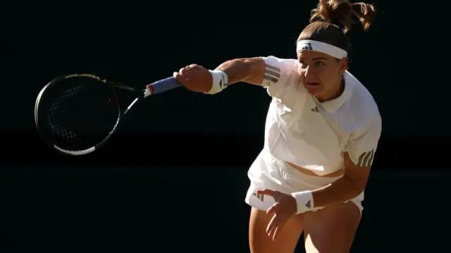 Karolina Muchova delivers a powerful serve during her match at the Wimbledon 2026 final.
