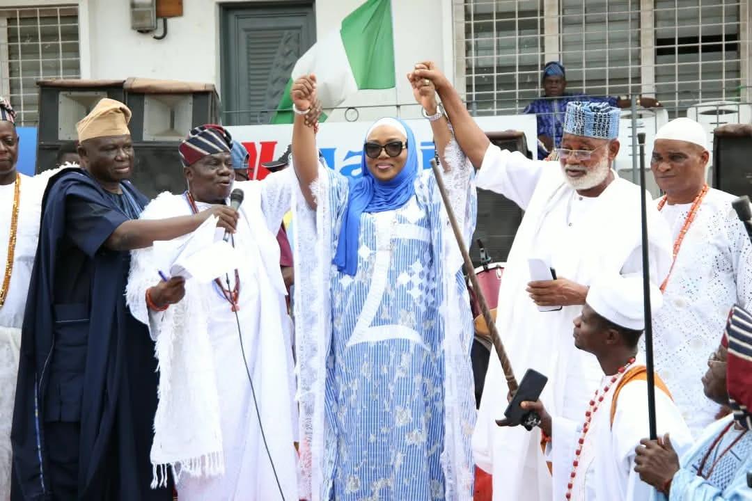 Community leaders in Itoku, Abeokuta, raising the hand of Hajia Lateefat Sowunmi-Kolapo during her reception.