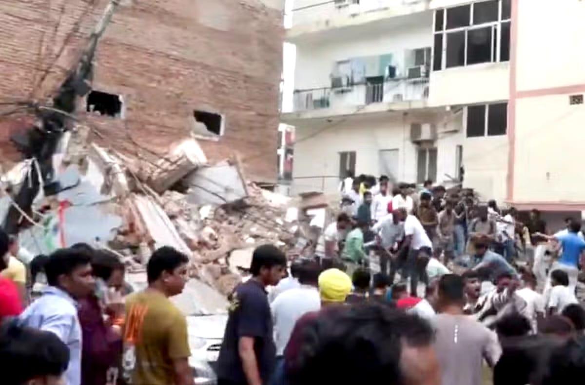 Rescue efforts underway amidst the rubble of the collapsed building in Delhi, where many students are feared trapped.