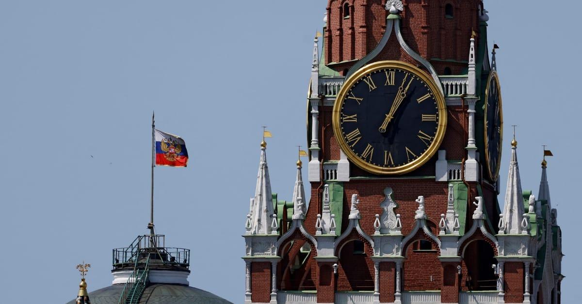The Russian flag prominently displayed on the dome of the Kremlin Senate building in Moscow, Russia.