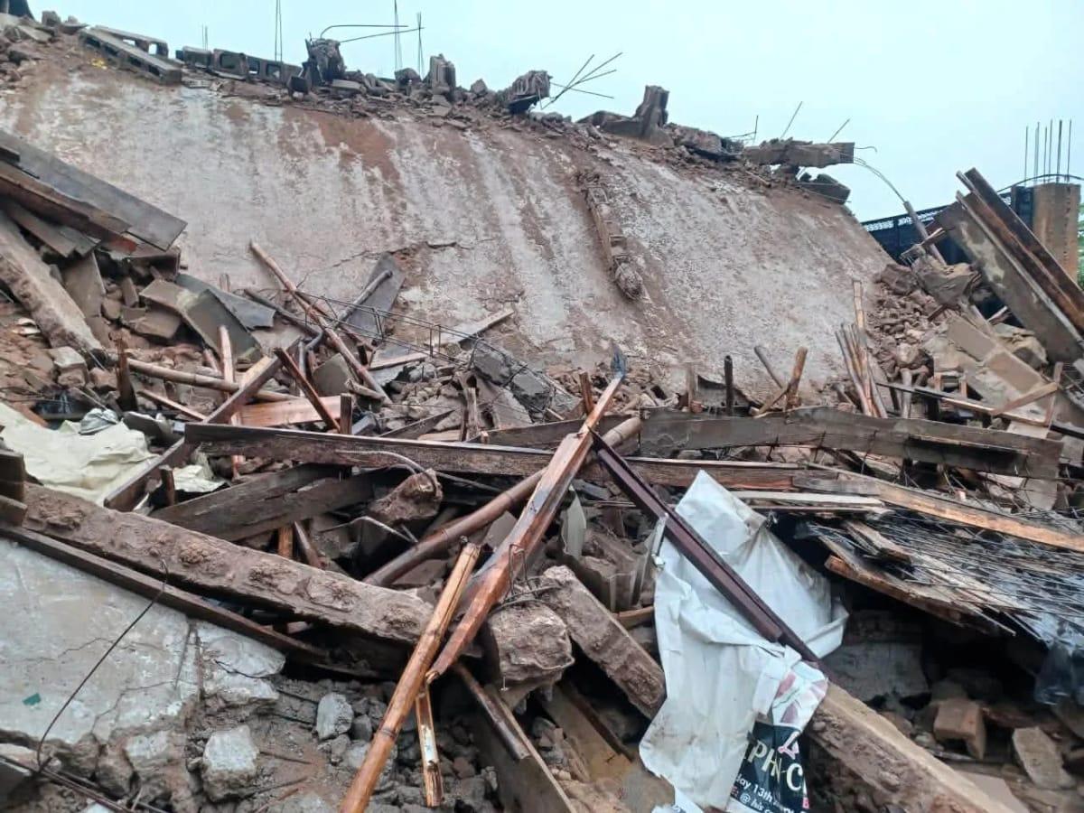 Residents and officials surveying the damage following the fatal building collapse in Anambra.