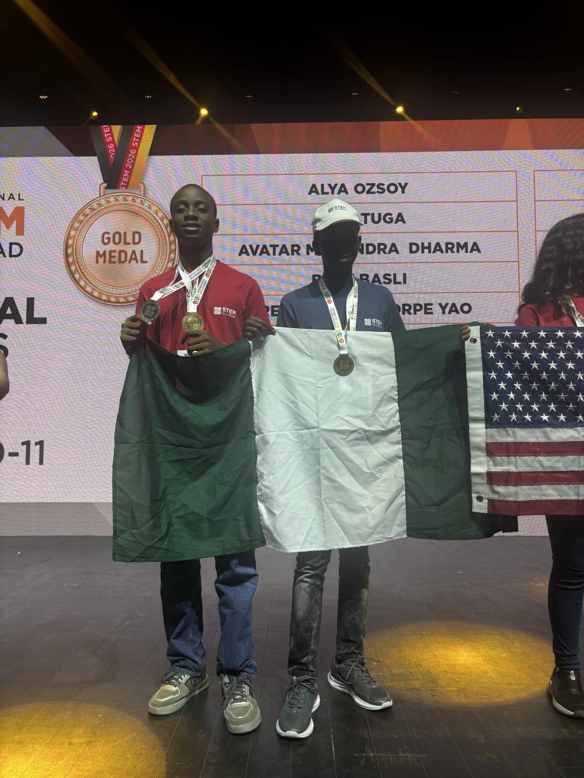 The triumphant Nigerian students, Chimdiebube Onwubiko, Don Anele Munachimso, and Egejurum Onyedikachi, proudly displaying their gold medals from the International STEM Olympiad.