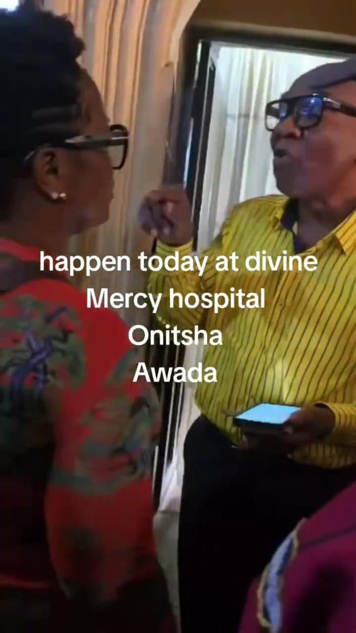 The suspect, wearing a nurse's uniform, being detained by hospital staff after an alleged attempt to steal a newborn.