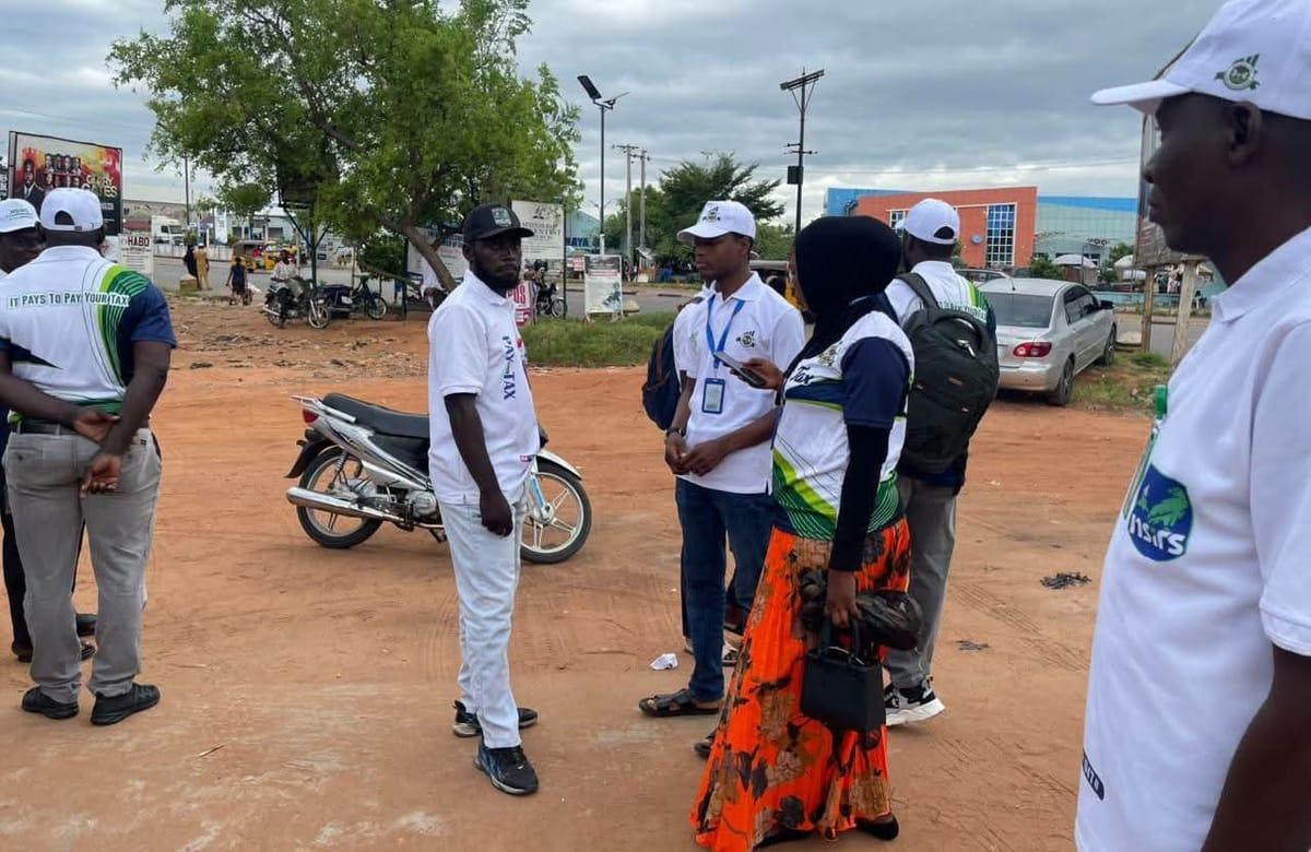 Staff members of the Nasarawa State Internal Revenue Service gathered outside the locked gate in Lafia.