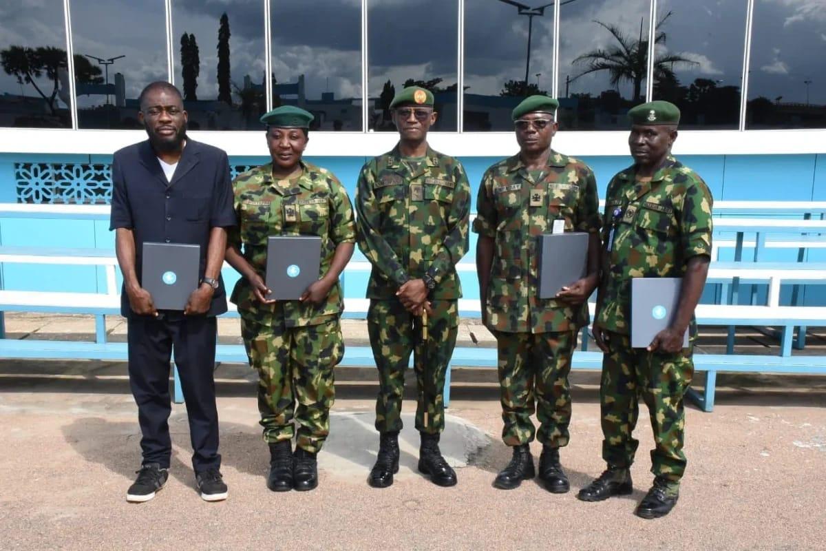 The four honored retiring officers from the Nigerian Army's 1 Division posing for a group photograph after the ceremony.