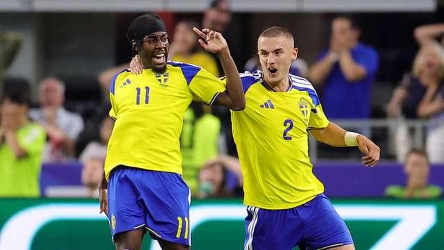 Players from Japan and Sweden battle for possession during their Group F encounter.