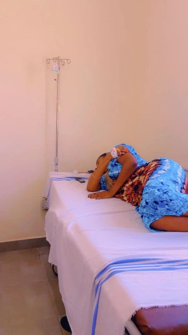 A scene suggesting medical attention or a hospital environment, reflecting the first wife's condition.