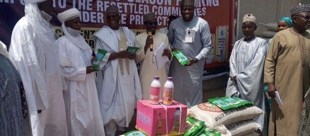 Eng. Ali Gumel, BUA Cement's Director of Health, Community Safety, and Environment, hands over farm inputs to community leaders in Sokoto.