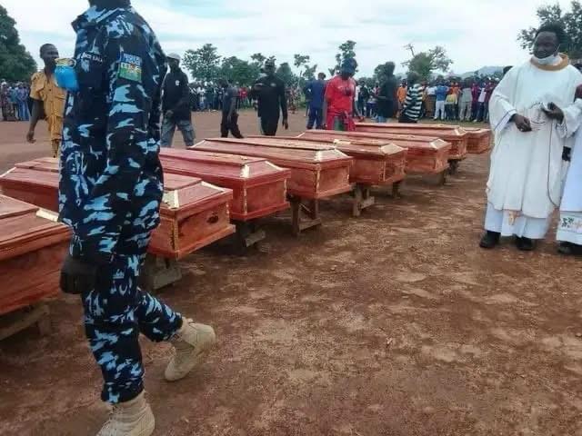 Community members paying their last respects to the victims during the burial.