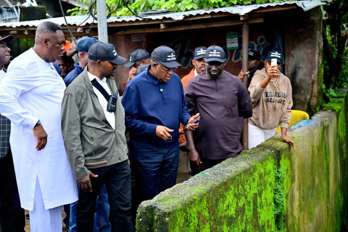 Governor Bassey Otu engaging with community members during his assessment of flood damage in Calabar.