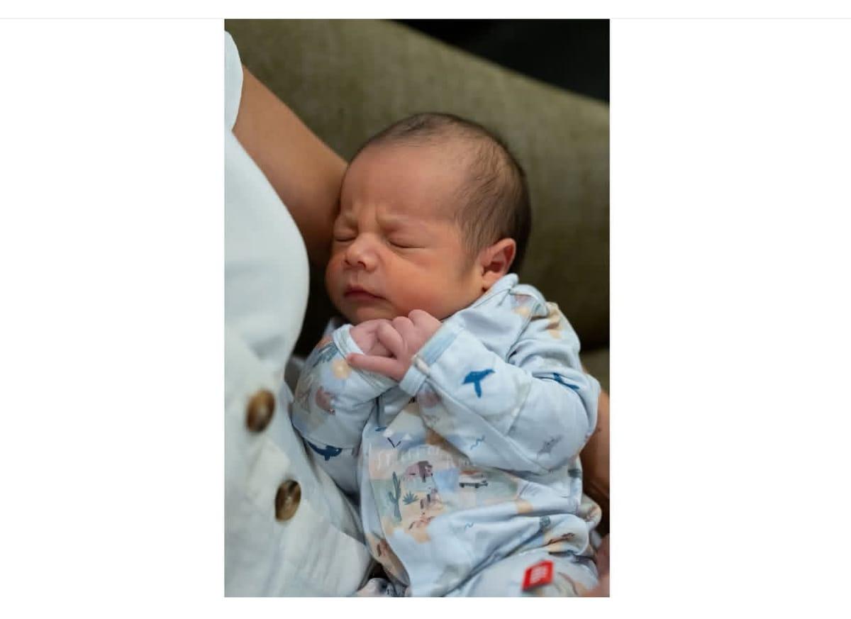 Second Lady Usha Vance cradles her newborn son, Alec Neel Vance, alongside US Vice President JD Vance and their other children in a family photo.