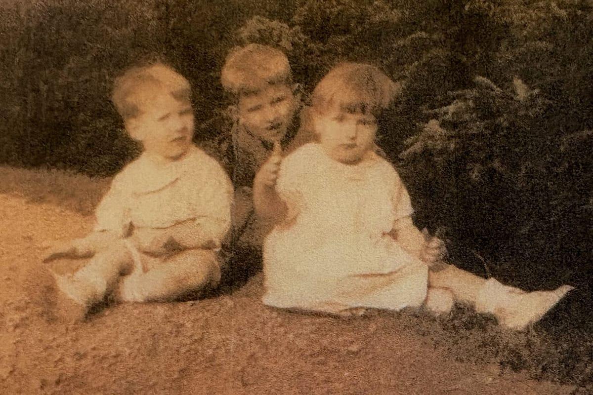 The twins as children, with their older brother Richard