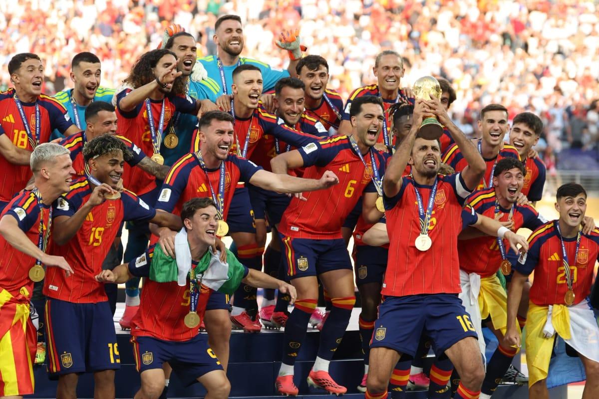 Spain's midfielder #16 Rodri and teammates celebrating with the trophy after winning the 2026 World Cup final match against Argentina.