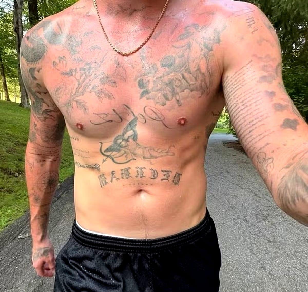 Brooklyn Beckham showcasing his chest, where new tattoos have replaced older ones dedicated to his family.