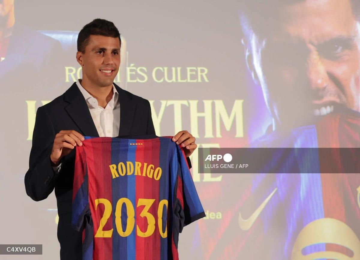 Spanish international Rodri poses with his FC Barcelona jersey during his official presentation.