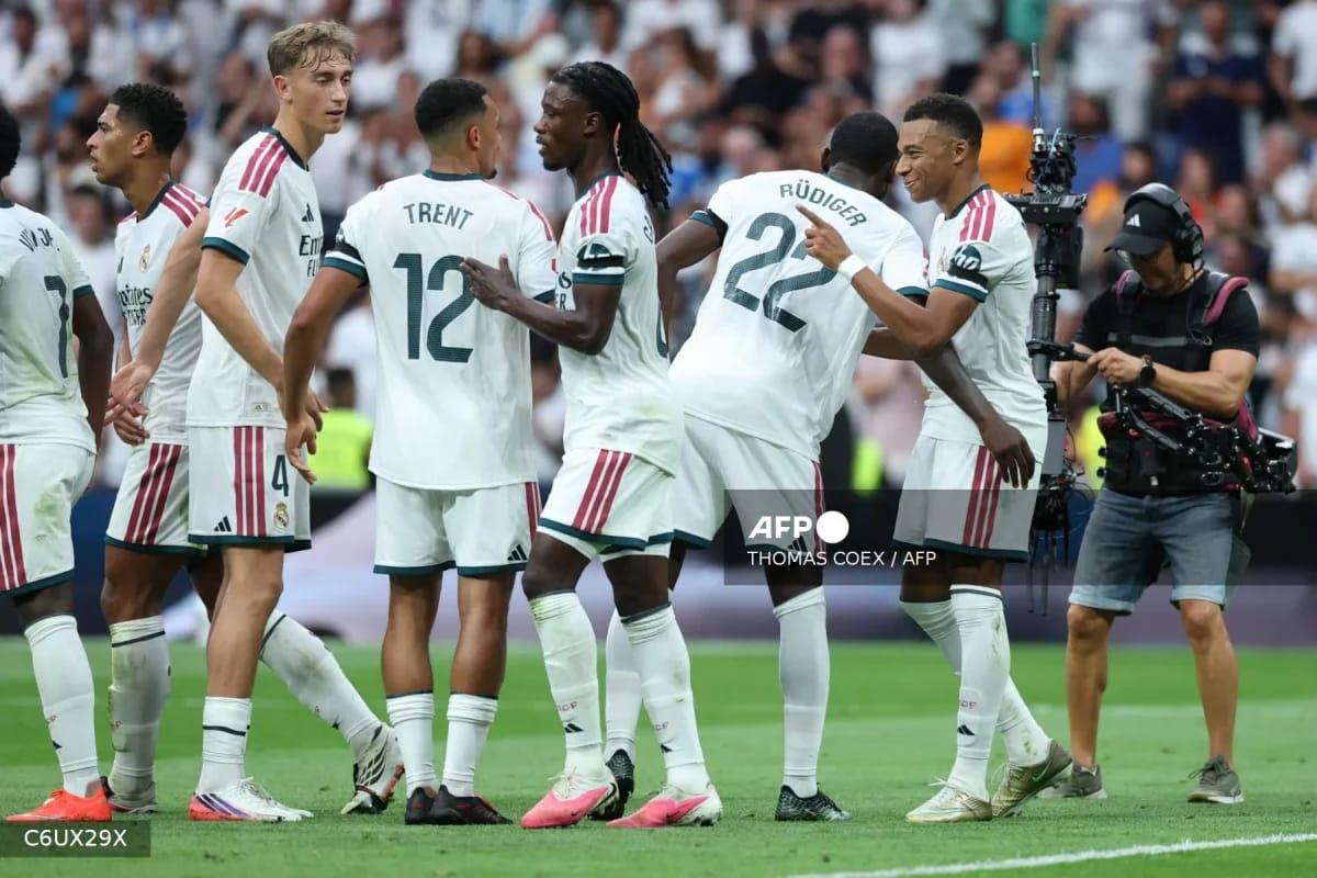 Real Madrid's French forward Kylian Mbappe (right) celebrates his goal with teammate Antonio Rüdiger during the La Liga match against Malaga at Santiago Bernabéu Stadium.