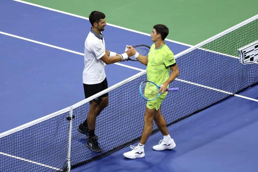Novak Djokovic receiving medical attention during his challenging US Open match.
