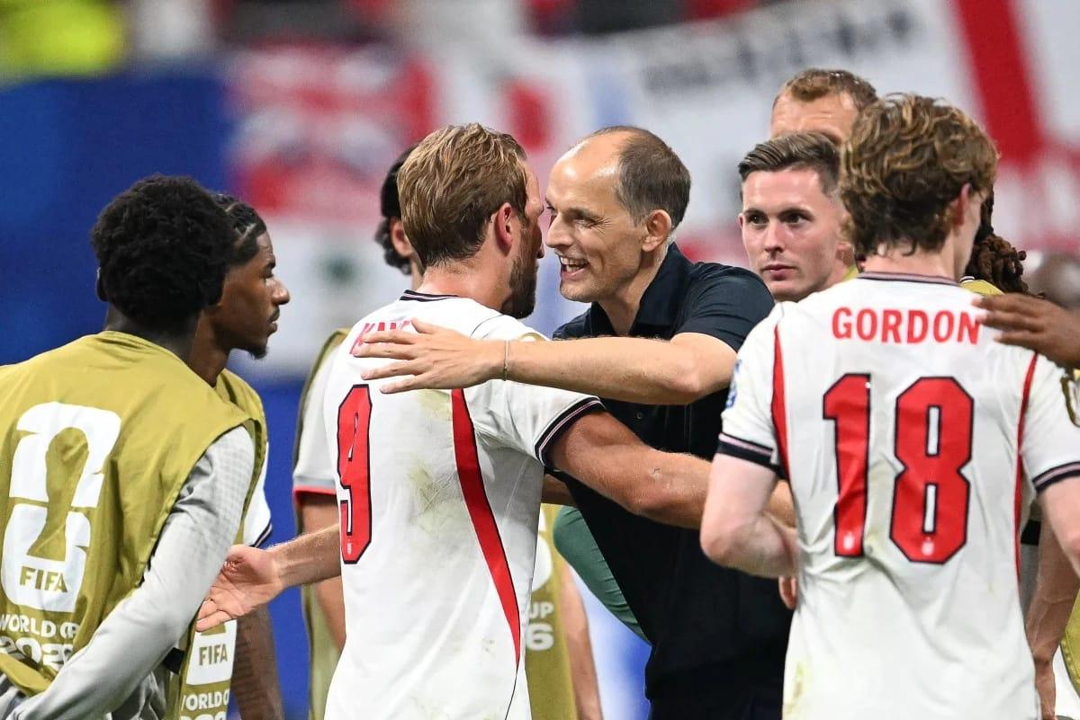 England's forward Harry Kane celebrating a goal with Head Coach Thomas Tuchel after a 2026 World Cup match.