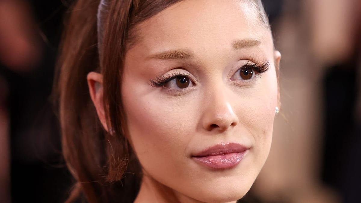 Ariana Grande showcasing her new, sleek, jaw-length bob haircut with a deep side part.