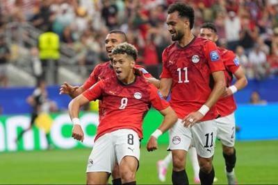Emam Ashour of Egypt celebrates after scoring his team's opening goal against Australia.