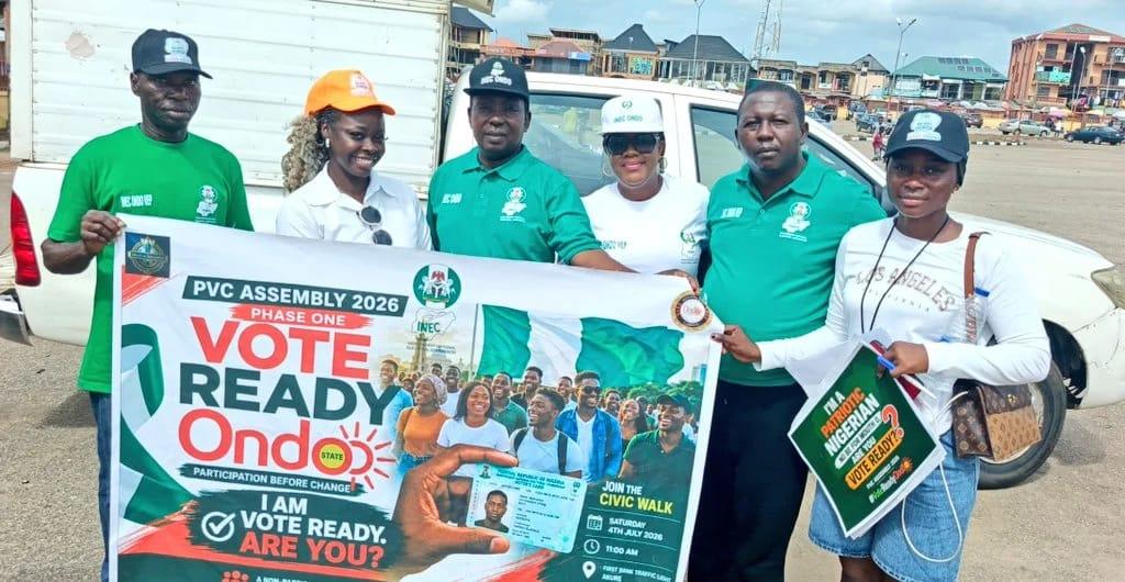 Residents of Akure receiving information on the Continuous Voter Registration process from awareness campaign participants.
