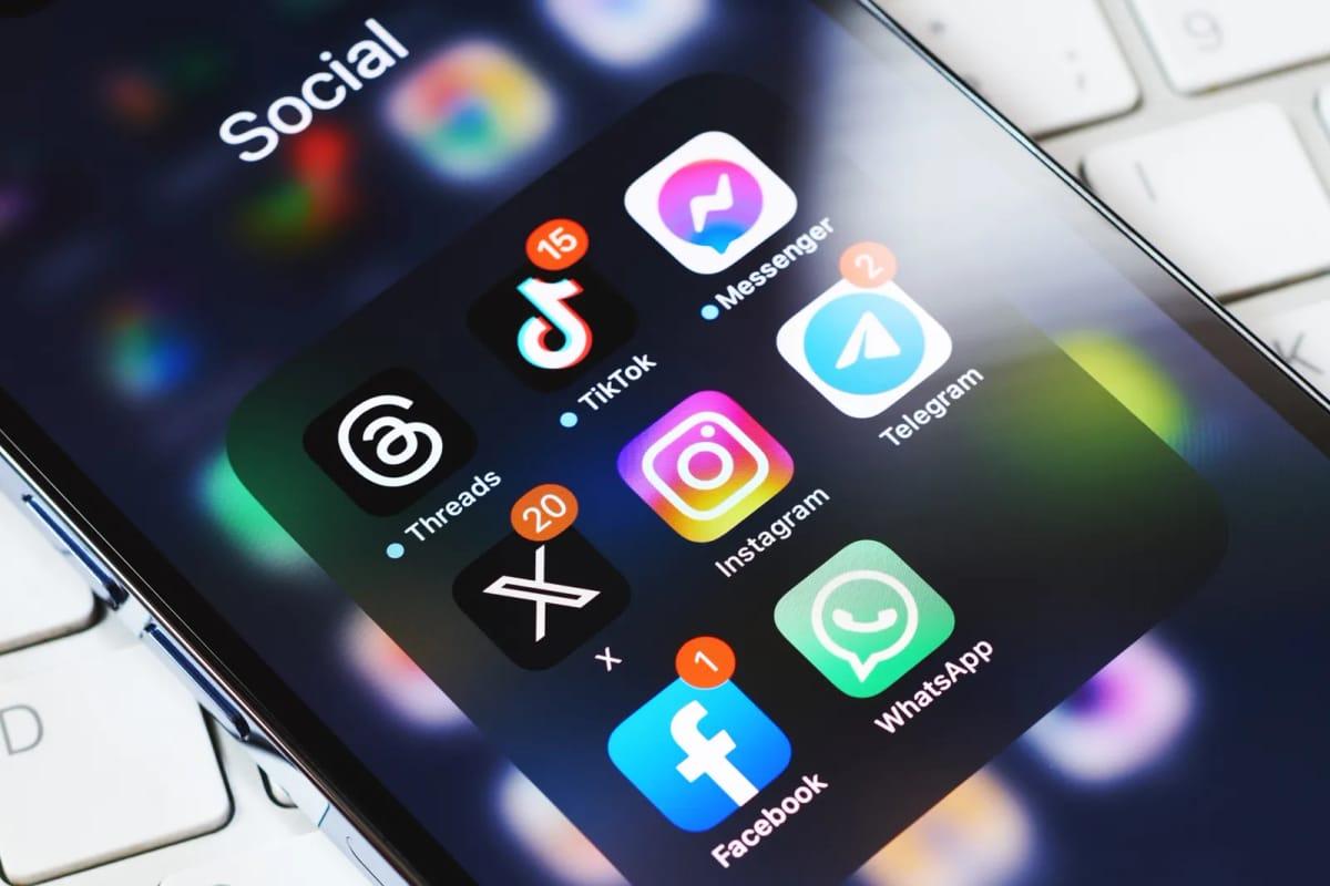 Close-up of popular social media apps like Threads, X, Instagram, Facebook, and WhatsApp on a mobile device, at the heart of the EU's proposed 'Kids Act'.