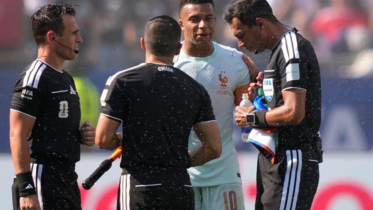 Kylian Mbappé reacts after a play on the field.