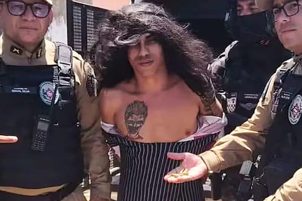 The suspect, Jorlan Lopes da Silva, seen in female disguise during his apprehension by Brazilian police.