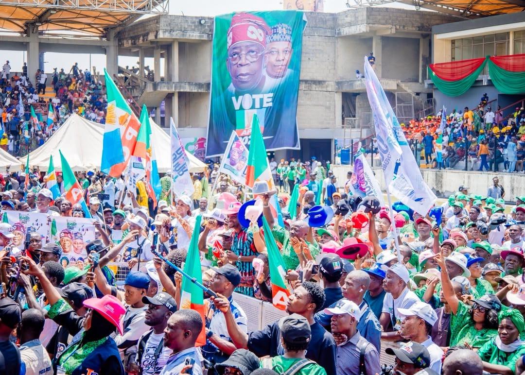 A vibrant scene of political mobilization, showing community engagement by the PBAT Door-to-Door Movement.