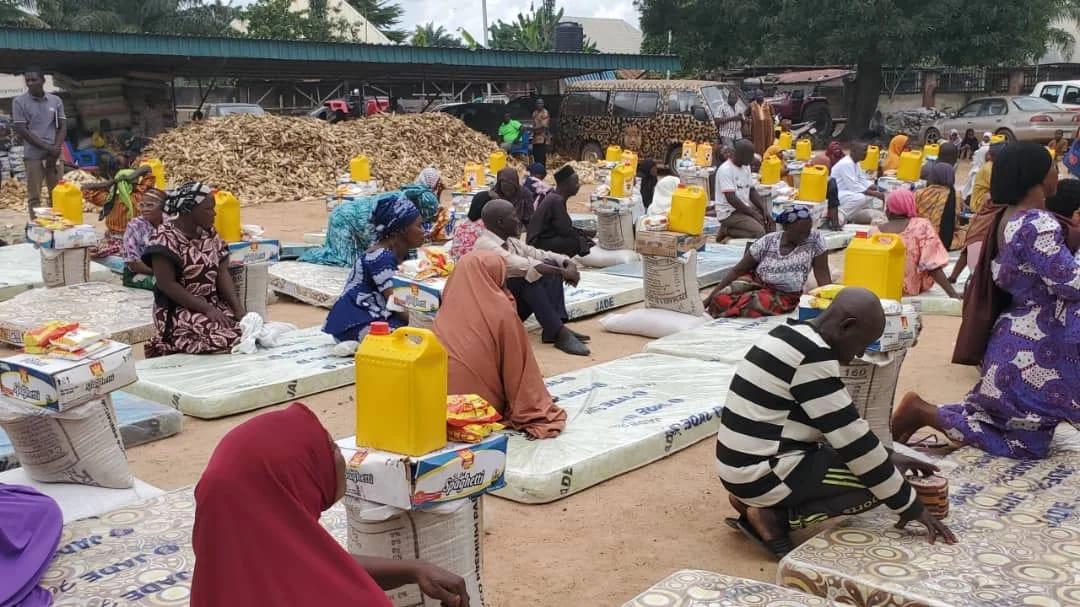 NASEMA Director-General, Benjamin Akwash, presents relief items to a beneficiary during the exercise in Akwanga LGA.
