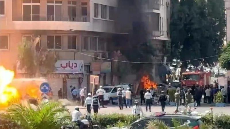 Explosions rock Damascus near a hotel, with plumes of smoke and flames visible