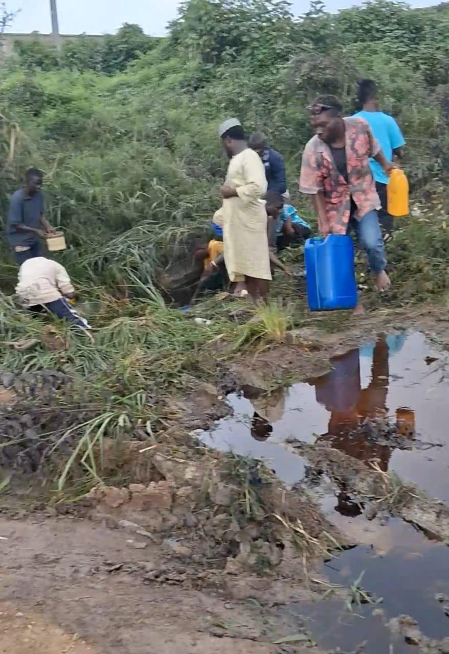 Emergency responders from FRSC and Fire Services at the scene of the fuel spill on Lagos-Ibadan Expressway, as residents gather.