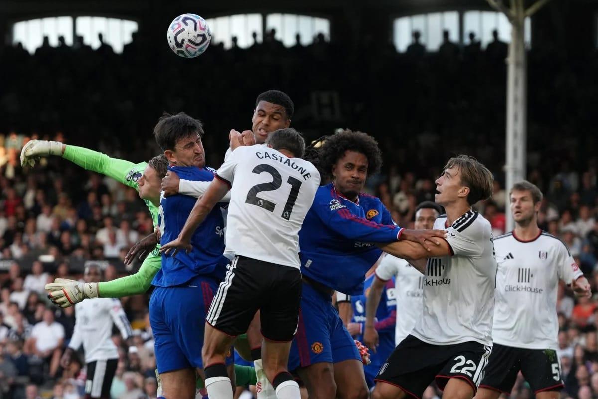 Players contest for the ball near the Fulham goal during the Premier League fixture at Craven Cottage.