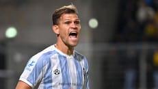 Florian Niederlechner in action during a football derby match.