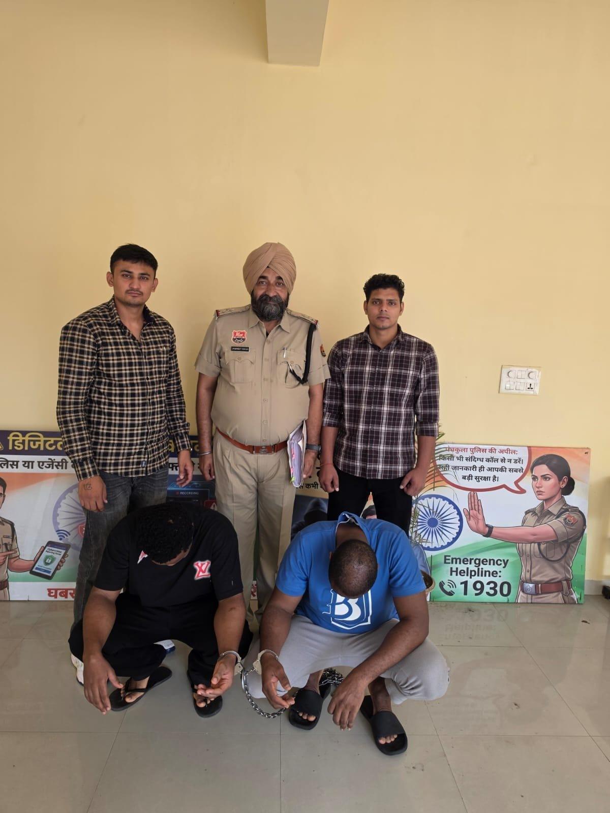 Individuals suspected of engaging in cyber fraud being apprehended.